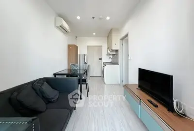 Modern living room with sleek furniture and open kitchen layout