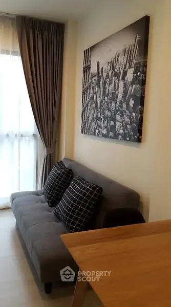 Cozy living room with modern sofa and cityscape artwork