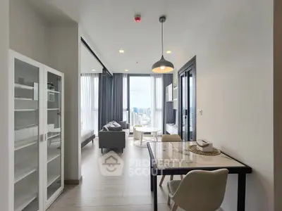 Modern living room with city view, sleek furniture, and natural light.