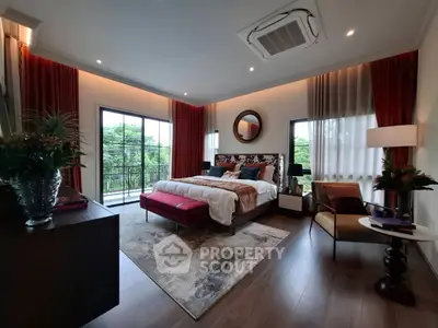 Luxurious bedroom with elegant decor and balcony view, featuring plush bedding and stylish furnishings.