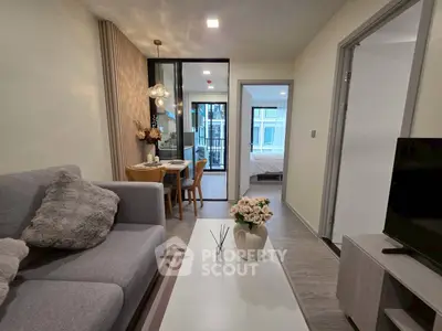 Modern living room with cozy decor and open view to bedroom, perfect for urban living.