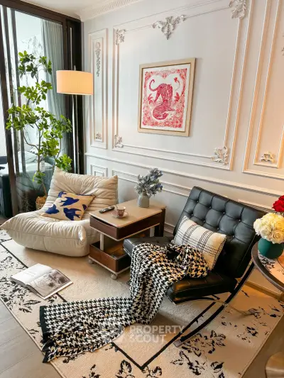 Elegant living room with stylish decor, featuring a cozy seating area, chic wall art, and lush greenery.