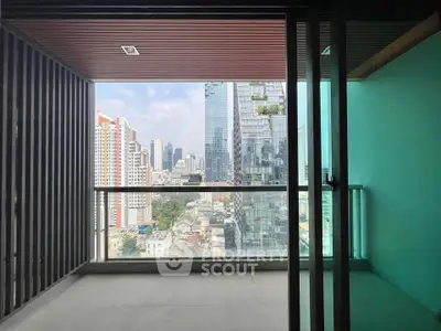 Spacious balcony with stunning city skyline view in modern high-rise apartment.