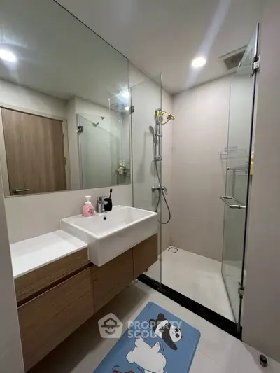 Modern bathroom with glass shower and stylish vanity