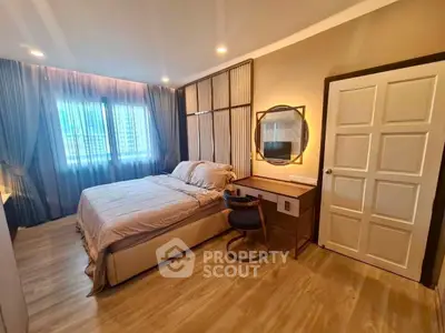 Cozy bedroom with modern decor, featuring a comfortable bed, stylish desk, and large window with city view.
