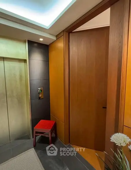 Modern elevator lobby with wooden paneling and stylish decor
