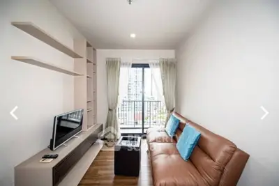 Modern living room with brown leather sofa and city view balcony