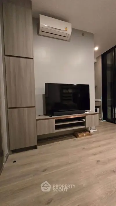 Modern living room with sleek TV unit and air conditioning