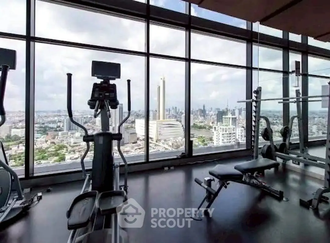 Luxurious high-rise gym with panoramic city views and modern fitness equipment.