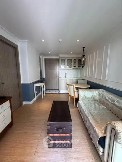 Charming living room with elegant decor and cozy seating in a stylish apartment.
