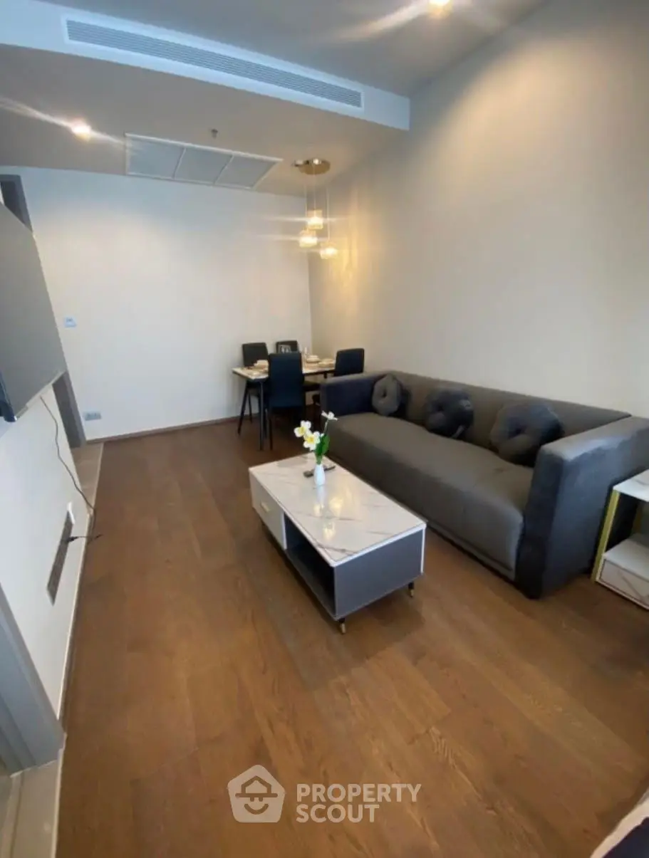 Modern living room with sleek furniture and elegant lighting in a stylish apartment.