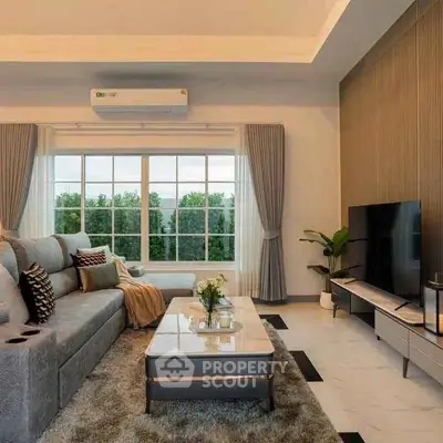 Luxurious living room with modern decor, large windows, and plush seating.