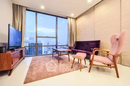Modern living room with city view, stylish furniture, and large windows in a high-rise apartment.