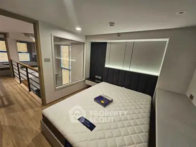 Modern bedroom with stylish design and large windows in a contemporary apartment.