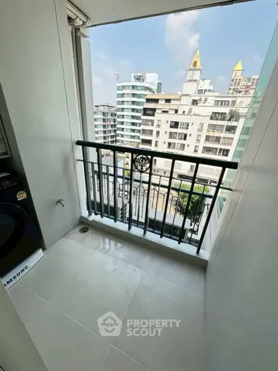 Charming balcony with city view, perfect for relaxation in a modern urban apartment.