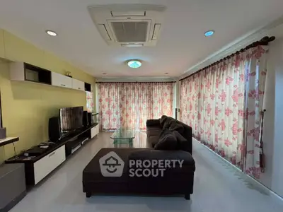 Spacious living room with modern decor and large windows for natural light.