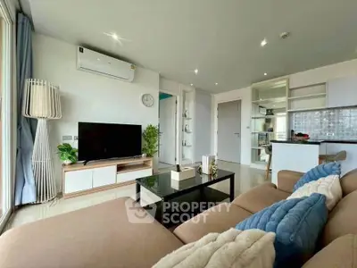 Modern living room with stylish decor and open kitchen layout in a cozy apartment.