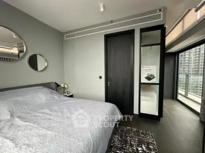 Modern bedroom with large windows and stylish decor in a high-rise apartment.