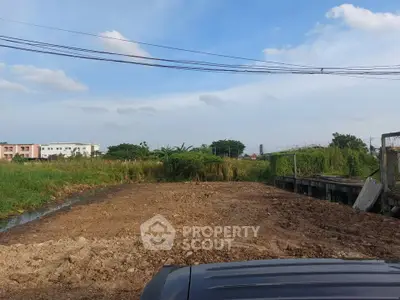 Vacant land plot with clear sky, ideal for development opportunities.