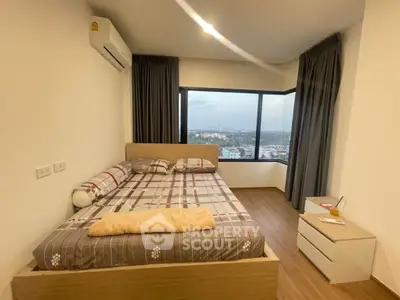 Cozy bedroom with panoramic city view and modern furnishings