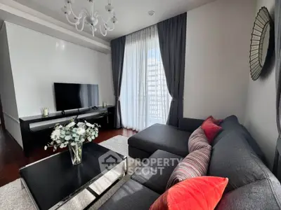 Modern living room with stylish decor, featuring a sleek TV setup and elegant curtains.