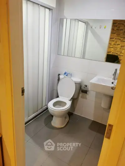 Modern bathroom with sleek fixtures and a spacious shower area, perfect for a contemporary home.