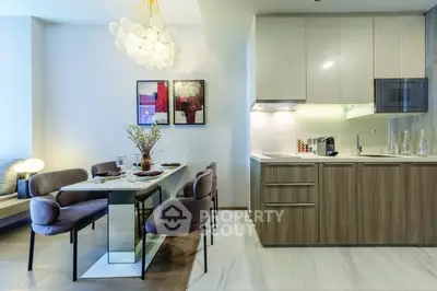 Modern kitchen and dining area with sleek design and elegant lighting