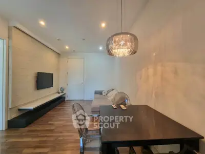 Modern living room with sleek furniture and elegant lighting, perfect for stylish urban living.