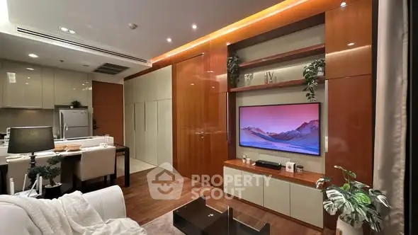 Modern living room with sleek design and integrated kitchen area, featuring stylish decor and ambient lighting.