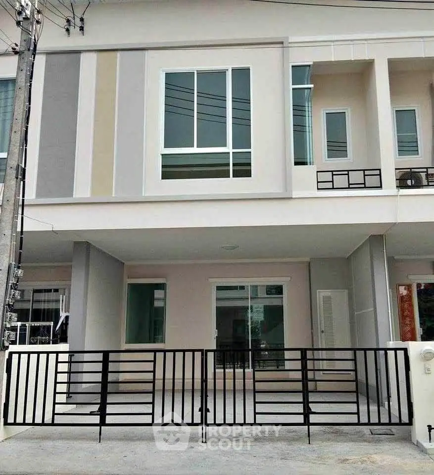 Modern townhouse exterior with sleek design and gated entrance