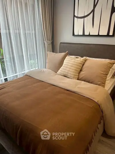 Cozy bedroom with elegant decor and large window for natural light