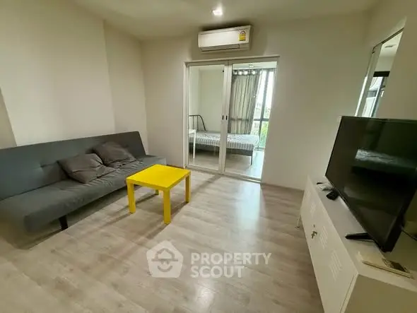 Modern living room with sleek furniture and bright yellow table