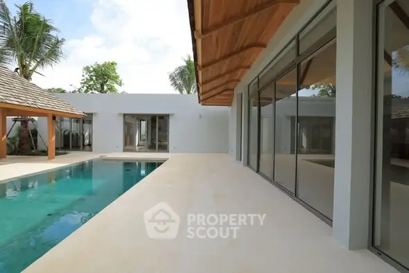 Luxurious modern villa with private pool and spacious patio area.