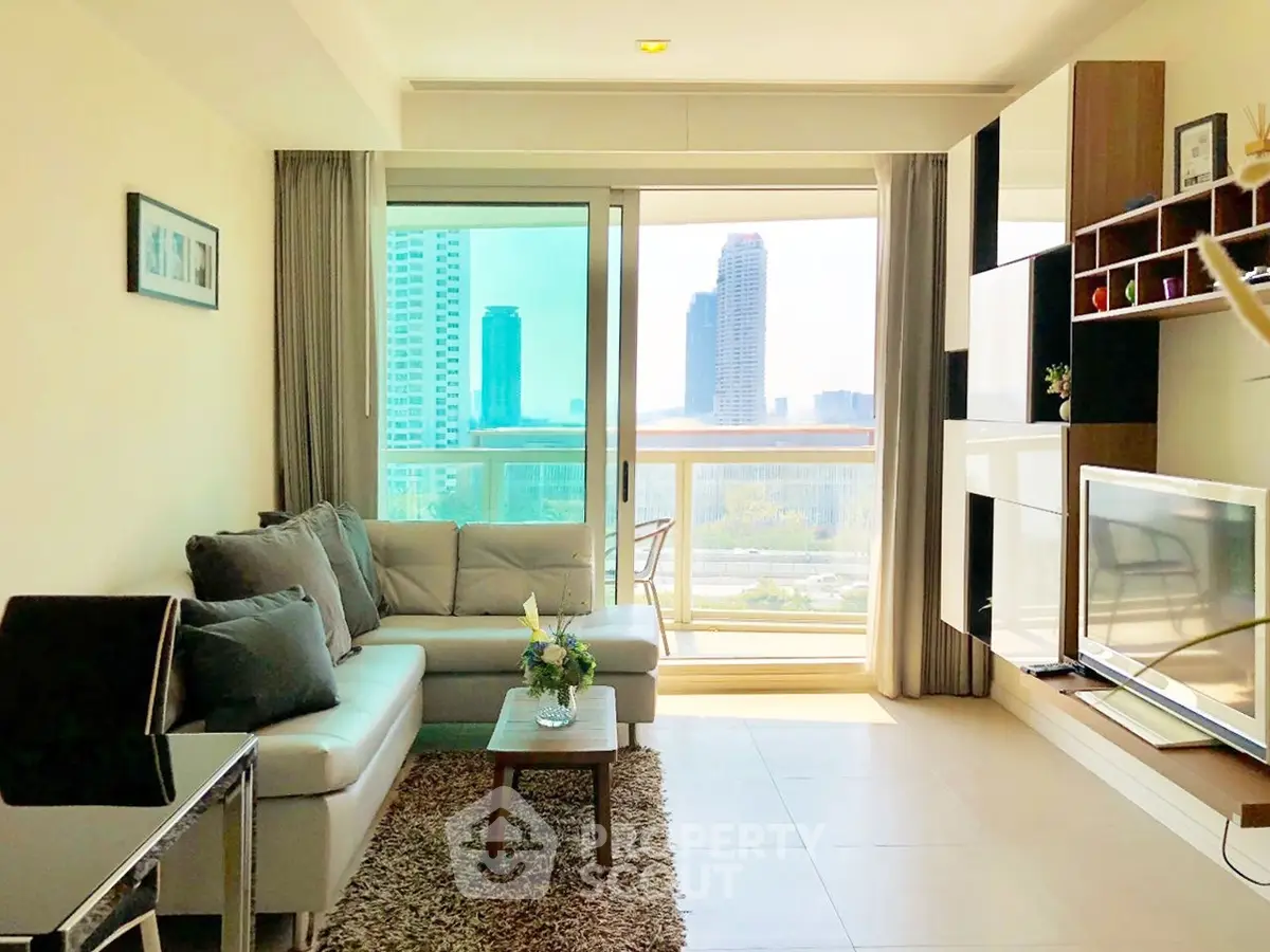 Spacious living room with modern decor and stunning city view from large windows.