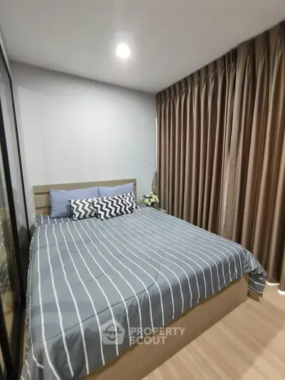 Cozy bedroom with modern decor and ample natural light