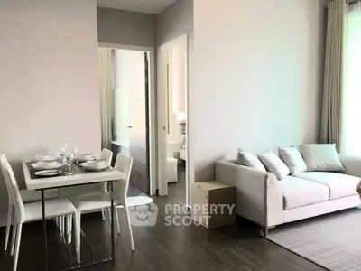 Modern living room with dining area and cozy sofa in a bright apartment