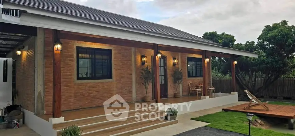 Charming single-story brick house with inviting porch and lush garden setting.