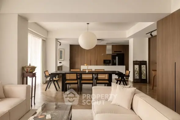 Spacious open-plan living room with modern kitchen and elegant decor