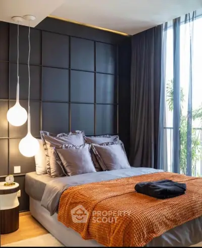 Luxurious bedroom with modern design, featuring elegant lighting and floor-to-ceiling windows.