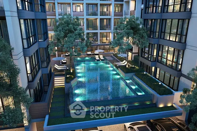 Luxurious modern apartment complex with illuminated swimming pool and lush greenery.