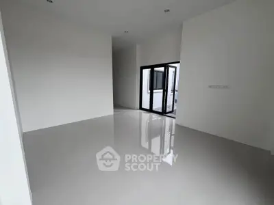 Spacious empty room with glossy white tiles and large windows, perfect for customization.