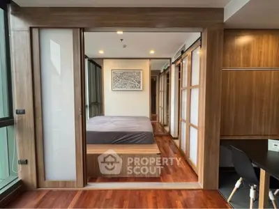 Modern bedroom with wooden accents and sliding doors in a stylish apartment