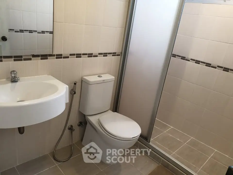 Modern bathroom with sleek fixtures and a spacious shower area.