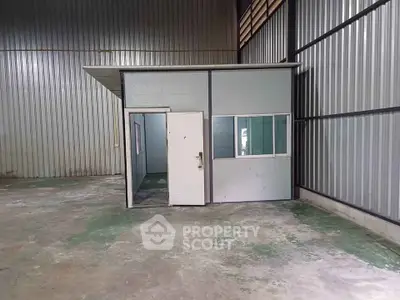 Spacious industrial warehouse with small office space, ideal for storage or business operations.
