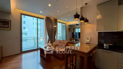 Modern living room with open kitchen and balcony view in luxury apartment