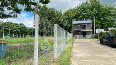 Charming rural property with spacious land and rustic building, ideal for development or agricultural use.