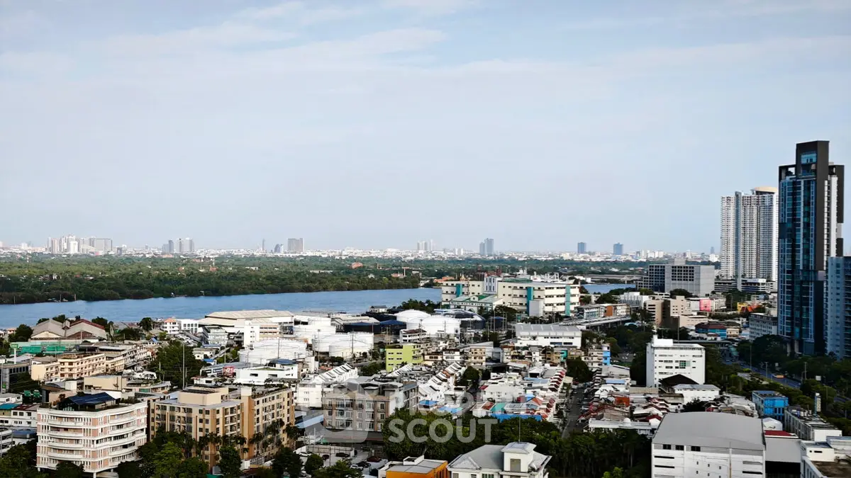 Stunning cityscape view showcasing modern high-rise buildings and serene river, perfect for urban living enthusiasts.