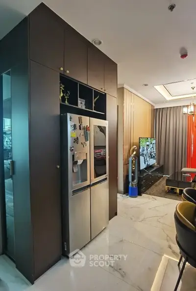 Modern kitchen and living room with sleek design and stainless steel appliances