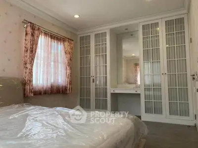 Charming bedroom with elegant built-in wardrobe and soft natural light