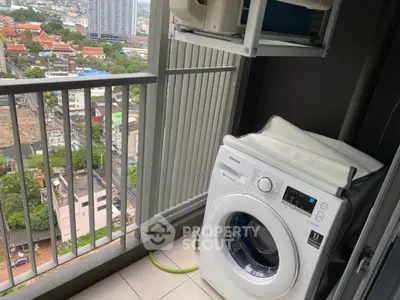 High-rise balcony with washing machine and city view, perfect for urban living convenience.